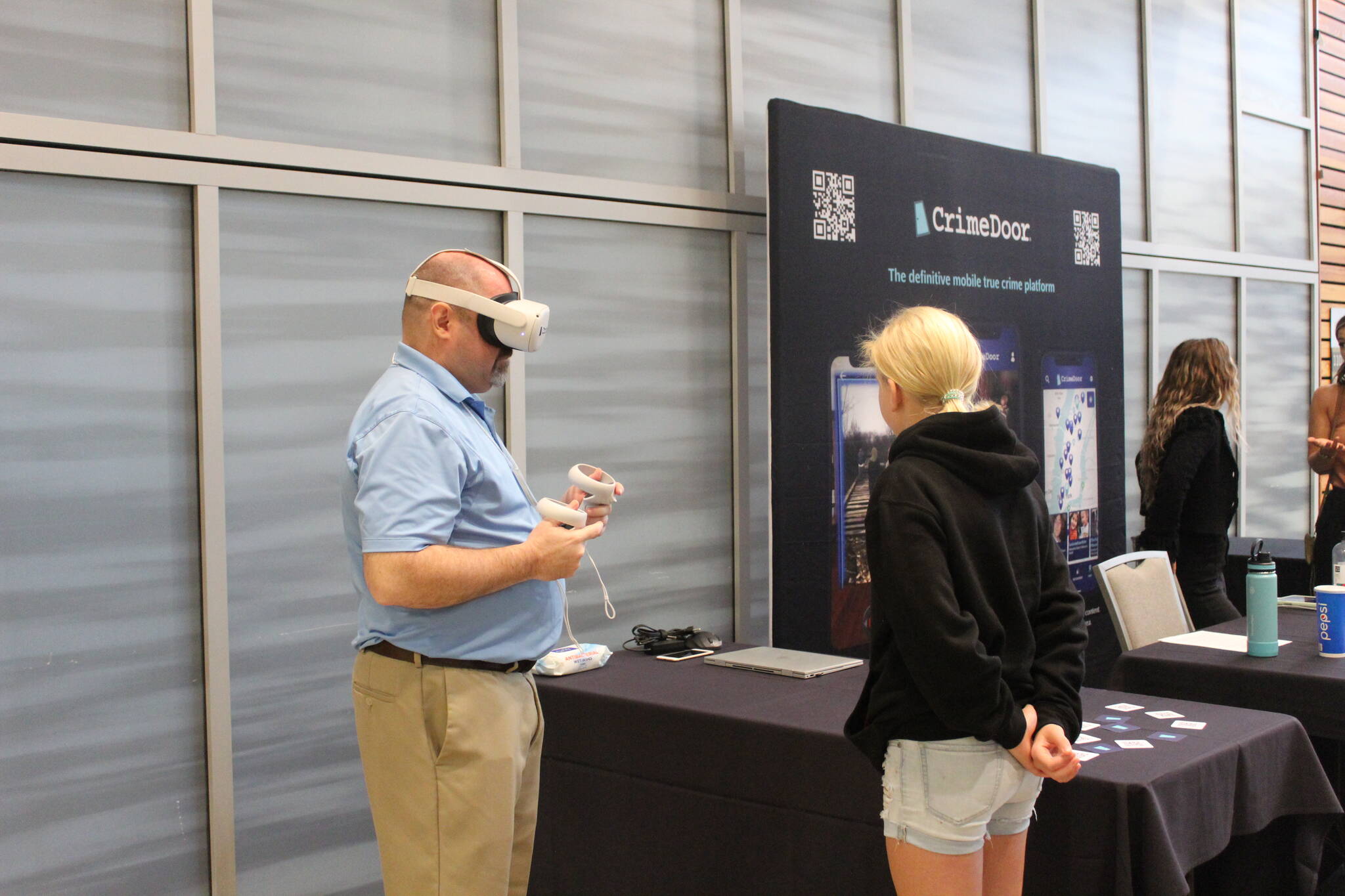 A guest is shown how to use augmented reality to explore the CrimeDoor app, a “definitive mobile true crime platform” that allows people to learn about and explore the sites and stories of true crime cases. Photo by Bailey Jo Josie/Sound Publishing