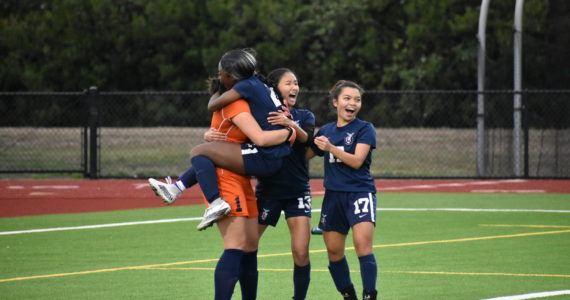 Rae’Ayn Gilbert leaping into Hailey Younts’ arms as Lindbergh won the game on penalty shots. Photo by Ben Ray/Renton Reporter