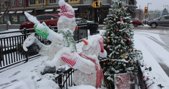 A festive winter display complete with snowmen, presents and a Christmas tree is covered in snow on Dec. 20. Photo by Bailey Jo Josie/Sound Publishing