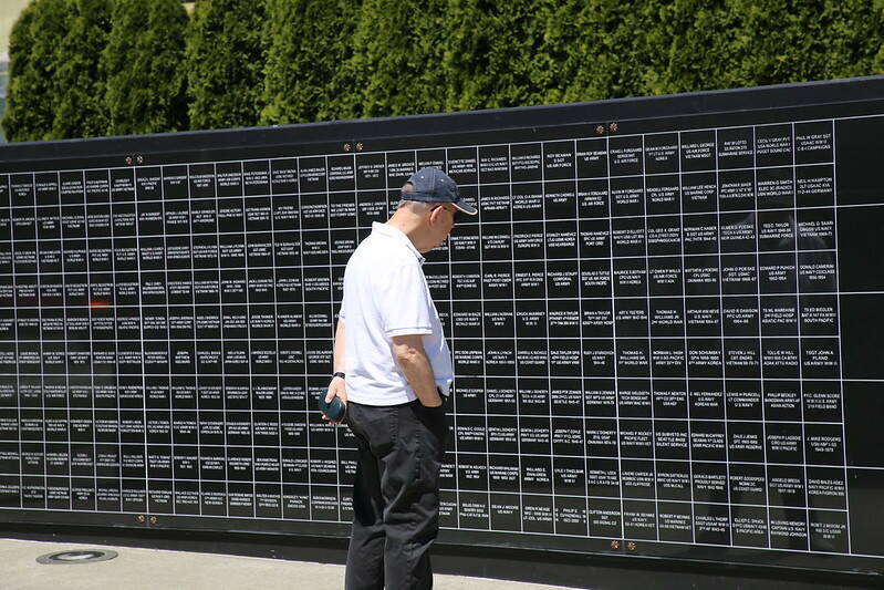 A man reads the names of U.S. veterans at Renton’s Veterans Memorial Park. Photo courtesy of the City of Renton.