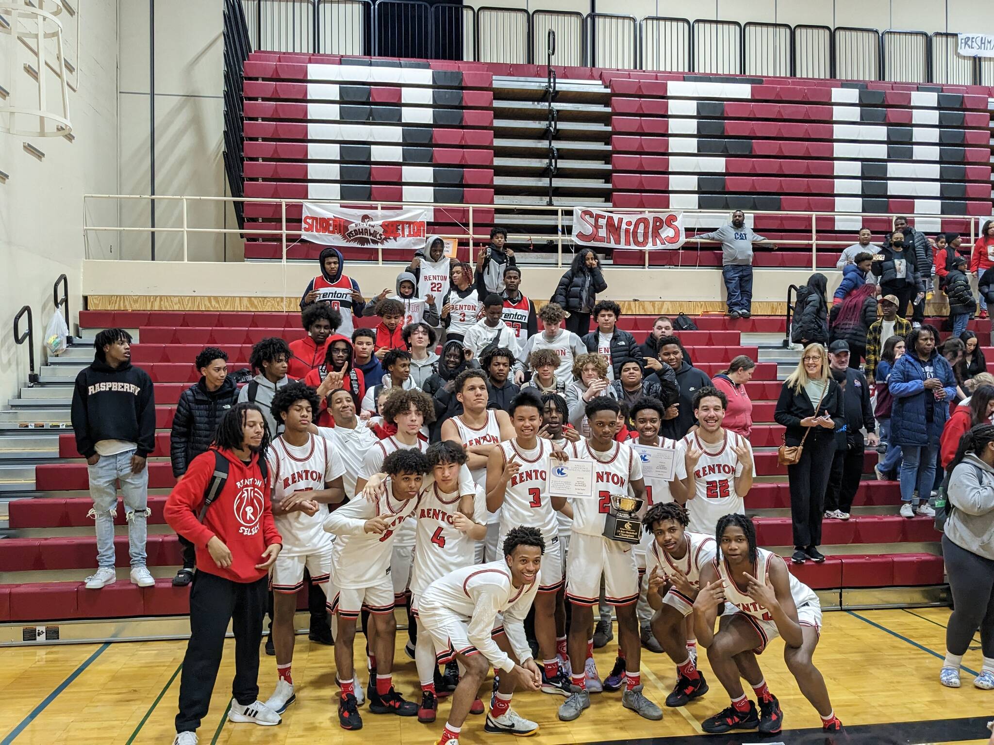 Renton boys pose with the student section after their KingCo championship victory. Ben Ray / The Reporter