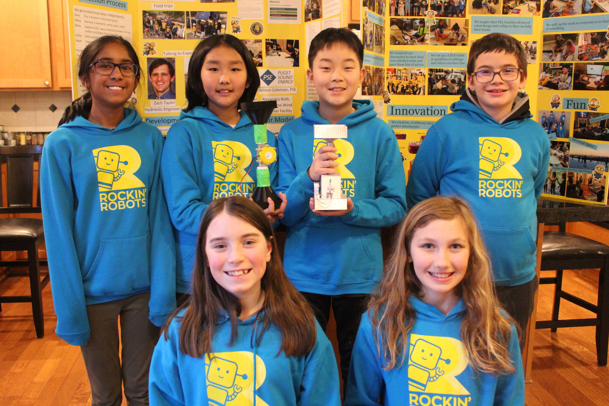 The Rockin’ Robots pose with their first and final hydro-powered waterspout prototypes, which earned them a second-place trophy. The energy from their project is enough to charge a Kindle, said the team. Photo by Bailey Jo Josie/Sound Publishing.