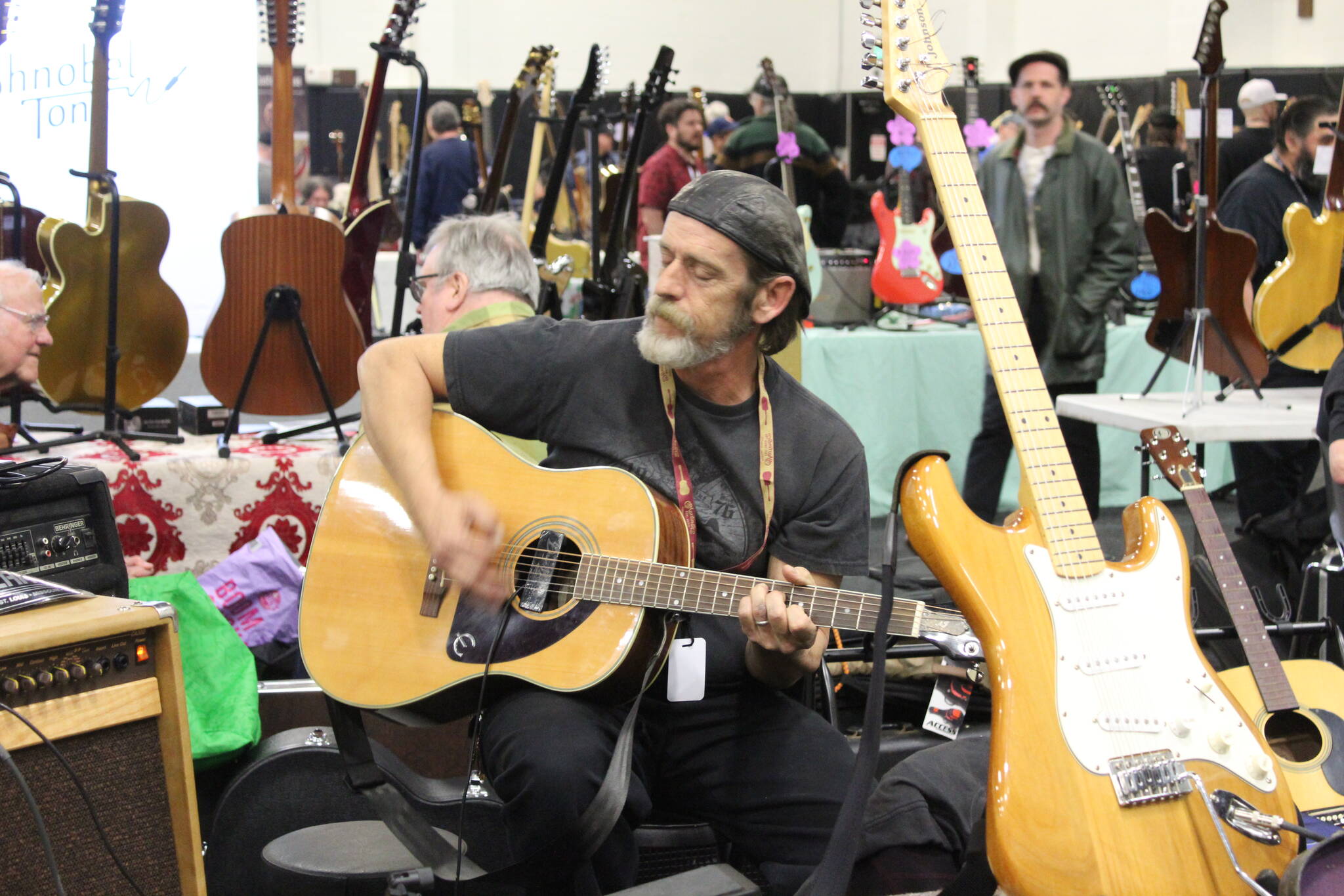 One vendor takes a break to play some music. Photo by Bailey Jo Josie/Sound Publishing