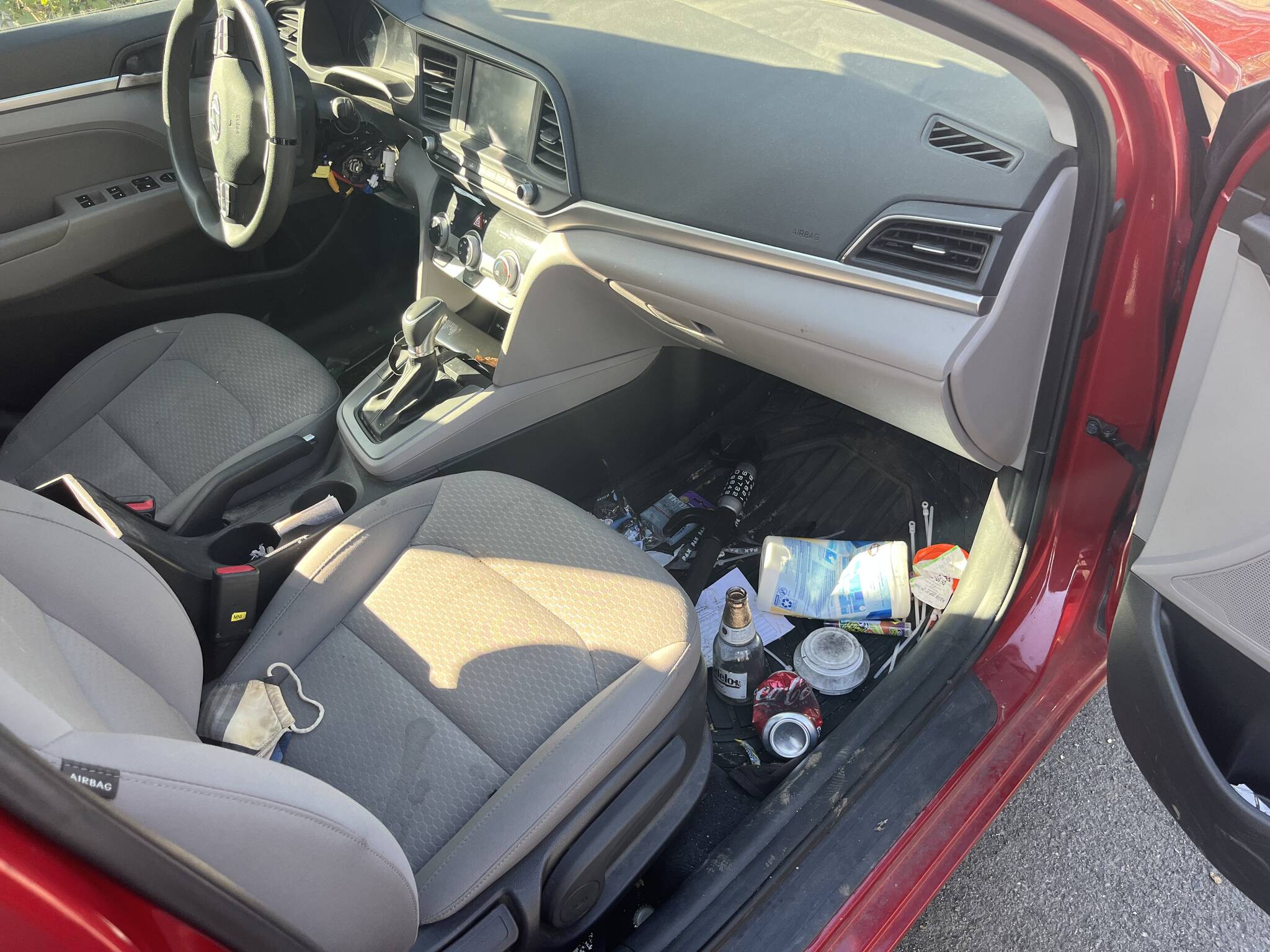A glass of beer, a joint, a box of unopened condoms and a steering wheel lock on the floor of Doug Lindquist’s 2019 Hyundai Elantra. (Photo by Ben Leung/Renton Reporter)