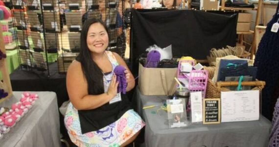 Jessica Bowen crochets while at her Renton River Days vendor stand. (Photo by Annika Hauer/For the Reporter)