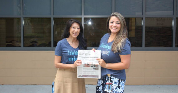 Photo by Annika Hauer/For the Reporter 
Linda Hoste, left, and Norma Taylor, right, holding a 2018 issue of the Renton Reporter.