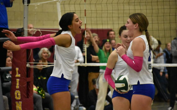 Kendreah Beazer and Layne Ford celebrate a point in the second round of the District 2 3A tournament. Ben Ray / The Reporter