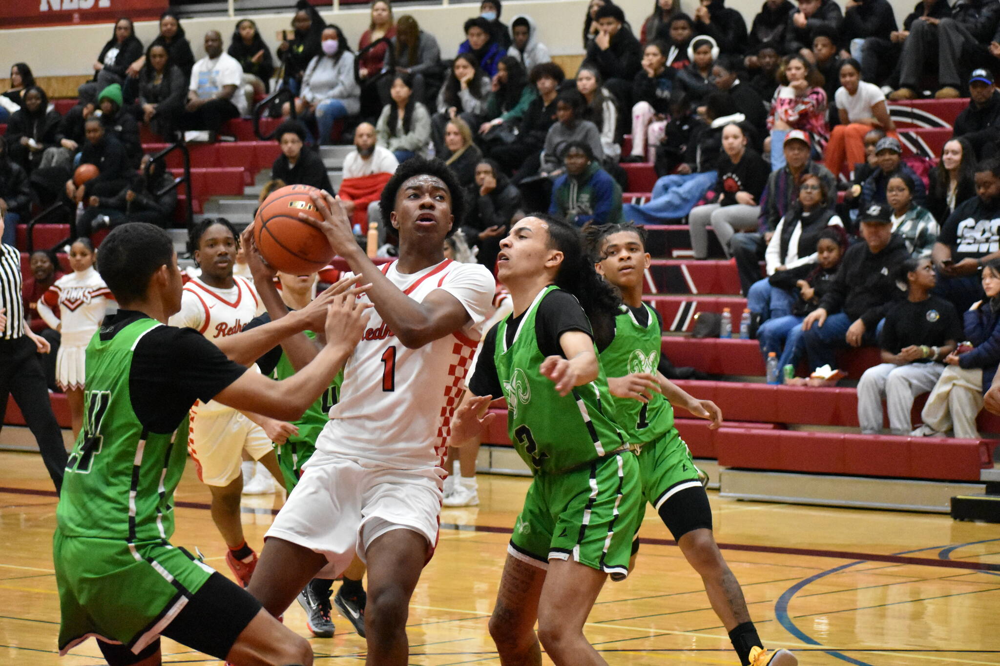 Dennis Johnson, a junior, battles through contact at home against Rancho (Nevada). Ben Ray/The Reporter