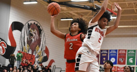 Jordan Agosto goes up for a lay-up with the back of a Sammamish defender on his side. Ben Ray / The Reporter