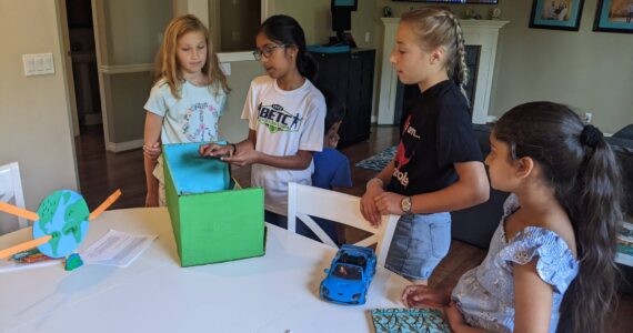 Photo courtesy of Julia Fishler
At the Kids Save The Earth event, Neha shows everyone the model for her litter-gathering robot. From left to right, Milla, Neha, Rohit, Callie and Dinaaz.