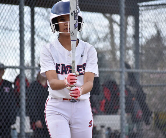 Raylyn Pocaigue looks at the barrel of her bat against Sammamish. Ben Ray / The Reporter