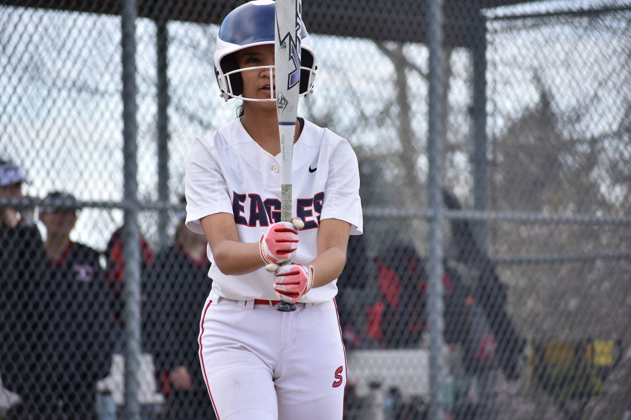 Raylyn Pocaigue looks at the barrel of her bat against Sammamish. Ben Ray / The Reporter