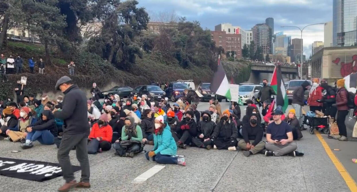 A scene of the Jan. 6, 2024, protest that blocked a freeway on-ramp in Seattle. (Screenshot)