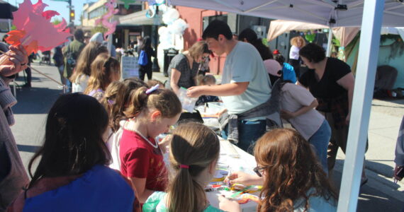 Kids making dragon arts and crafts at the Erasmus hatching party street fair. Photo by Bailey Jo Josie/Sound Publishing.