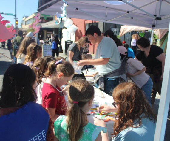 Kids making dragon arts and crafts at the Erasmus hatching party street fair. Photo by Bailey Jo Josie/Sound Publishing.