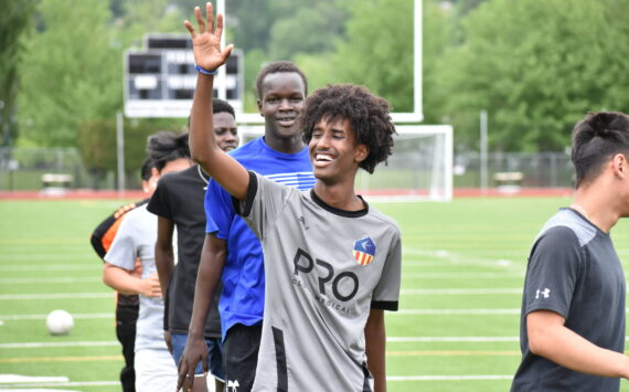 Mohamed Abdi gives a wave during training at Renton Memorial Stadium. Ben Ray / The Reporter