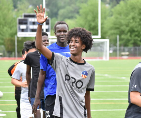 Mohamed Abdi gives a wave during training at Renton Memorial Stadium. Ben Ray / The Reporter