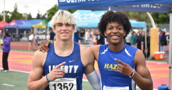 Kenyon Andrews (right) and Sutten Flint (left) pose after 300-hurdle race. Ben Ray / The Reporter