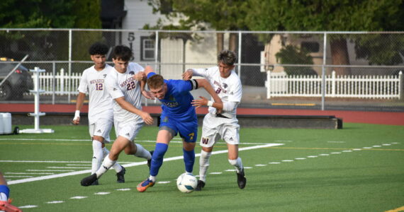 Vitaly Polyukh fends off three Wenatchee players. Ben Ray / The Reporter