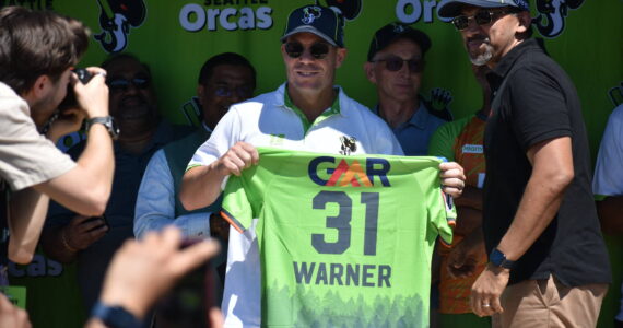 David Warner holds up his jersey for the Seattle Orcas. Ben Ray / The Reporter