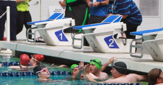 Special Olympics athletes high-five each other after a swim relay race at the 2025 Spring Games at the Weyerhaeuser King County Aquatic Center in Federal Way. The aquatic center is among recreational facilities and parks across the region that would receive upgrades with the passage of the King County Parks Levy on the Aug. 5 primary ballot. (File photo)