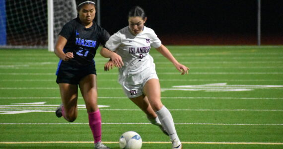 Jackie Gonzalez and Zoe Wong battle for the ball. Ben Ray / The Reporter