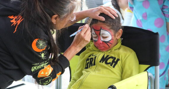 The Grinch becomes Spider-Man at the event’s free face painting booth. Photo by Bailey Jo Josie/Sound Publishing