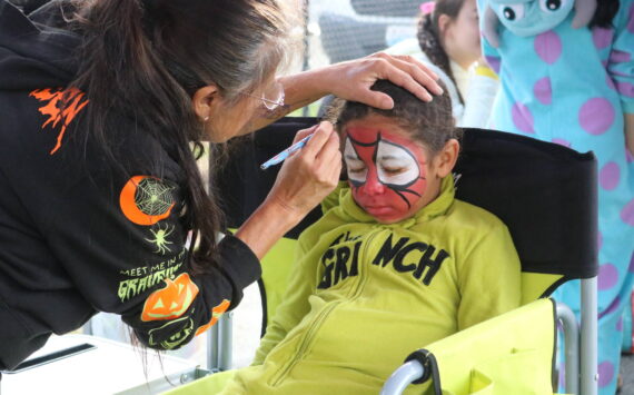 The Grinch becomes Spider-Man at the event’s free face painting booth. Photo by Bailey Jo Josie/Sound Publishing