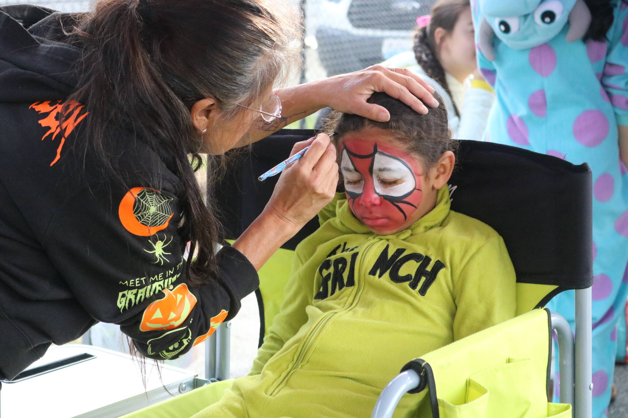 The Grinch becomes Spider-Man at the event’s free face painting booth. Photo by Bailey Jo Josie/Sound Publishing