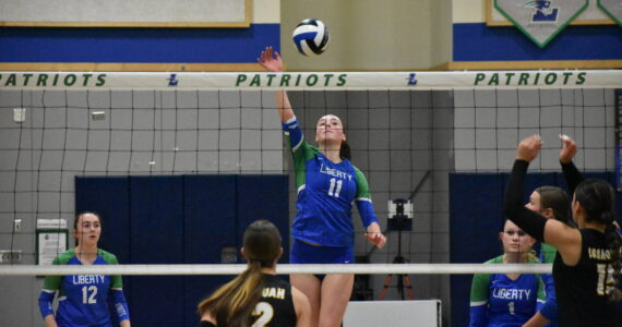 Julianne Lee with a tip over the net against Issaquah. Ben Ray / The Reporter