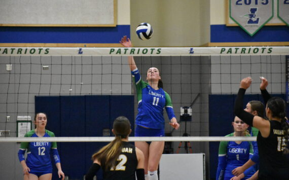 Julianne Lee with a tip over the net against Issaquah. Ben Ray / The Reporter