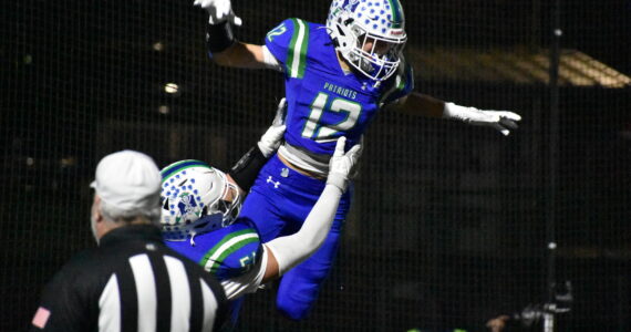 Tyke Hamilton lifted up after an interception taken back for a touchdown. Ben Ray / The Reporter