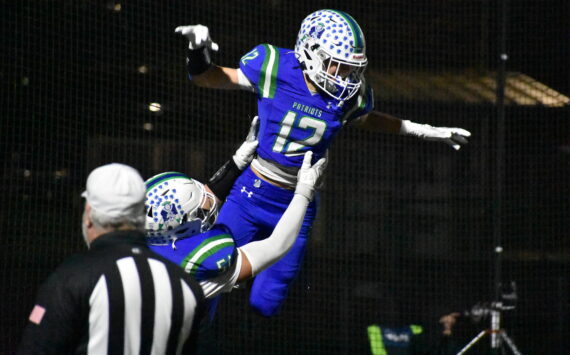 Tyke Hamilton lifted up after an interception taken back for a touchdown. Ben Ray / The Reporter