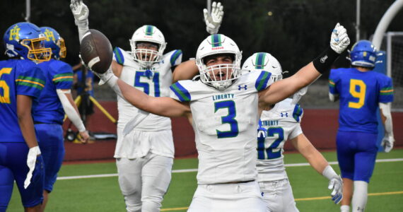 Ben Ray / The Reporter
Spencer Bogh stretches his arms out after scoring a touchdown against Hazen.