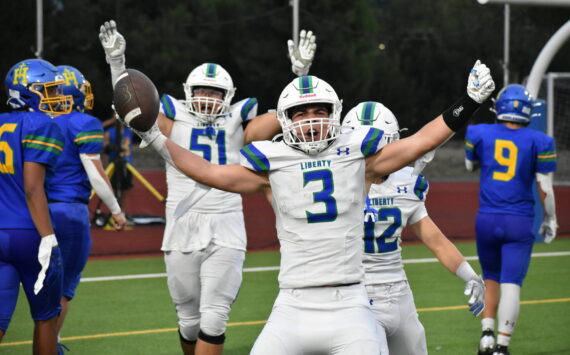 Ben Ray / The Reporter
Spencer Bogh stretches his arms out after scoring a touchdown against Hazen.