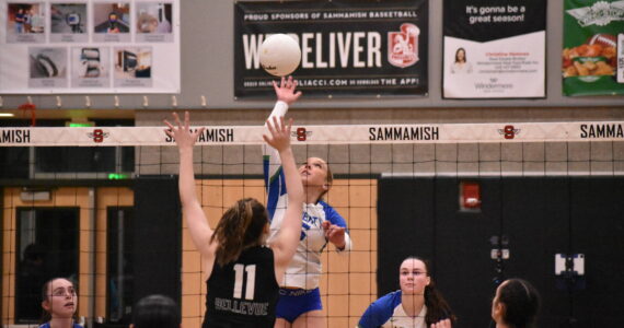Avery Bange with a spike against Bellevue. Ben Ray / The Reporter