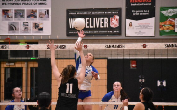 Avery Bange with a spike against Bellevue. Ben Ray / The Reporter