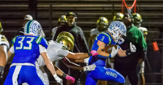 Spencer Bogh runs the ball for Liberty against Evergreen. Photo provided by Natasha Valach.