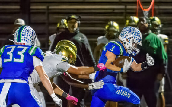 Spencer Bogh runs the ball for Liberty against Evergreen. Photo provided by Natasha Valach.