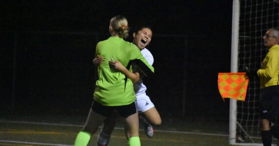 Peyton Warns and Mylene Augila embrace each other after beating Gig Harbor. Ben Ray / The Reporter