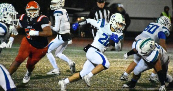 Josh Feren runs the ball for Liberty at Harry E. Lang Stadium in Lakewood. Ben Ray / The Reporter