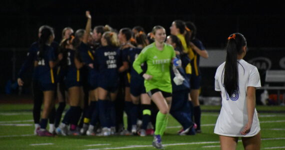 Callise Chin (foreground) and Peyton Warns (background) leave the field as Bellevue celebrates. Ben Ray / The Reporter