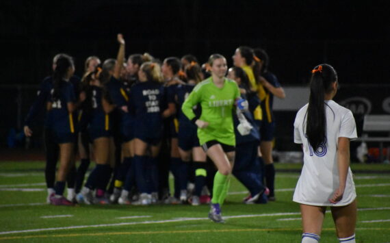 Callise Chin (foreground) and Peyton Warns (background) leave the field as Bellevue celebrates. Ben Ray / The Reporter