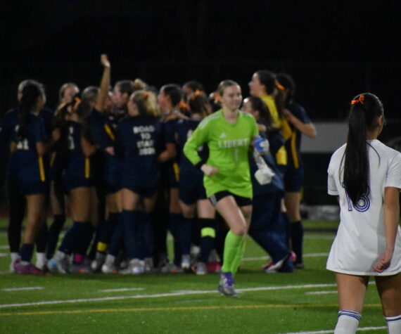 Callise Chin (foreground) and Peyton Warns (background) leave the field as Bellevue celebrates. Ben Ray / The Reporter