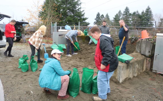 Maplewood residents and helpers fill up sandbag after sandbag at the county public sandbag station in the Highlands to keep the water from getting into their neighborhood. Photo by Bailey Jo Josie/Sound Publishing.