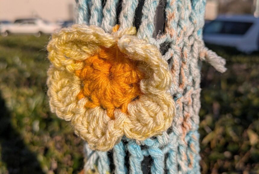 <p>Whimsical crochet fiber art adorns a traffic sign near Azteca Boxing Club, The Rose Gift House and Coffee, Tomato Tomäto Creative and Idolize Tattoo in downtown Renton. Photo by Bailey Jo Josie/Sound Publishing</p>