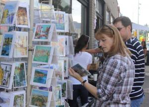 Gina Coleman of Renton checks out some postcards made by a local artist during the eighth annual Artwalk Aug. 24 downtown.