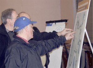 Fairwood resident Tom Remy points to one of the displays showing different aspects of the Fairwood incorporation study Monday night. He was among the skeptics in a crowd of about 200 people.