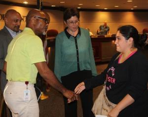 Councilman Greg Taylor shakes hands with Grisel Rodriguez