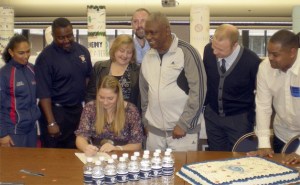Lindbergh’s Emily Graver signs her Letter of Intent to play basketball for Concordia University. Behind her (from left to right): Lindbergh assistant coach Victoria Chappell